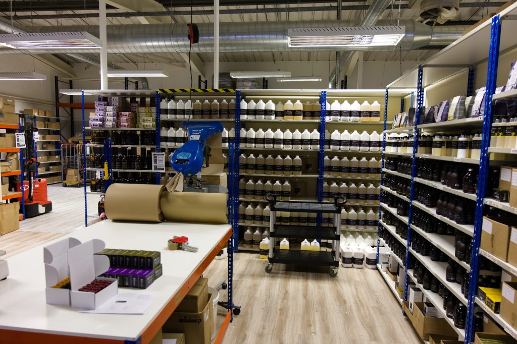 De inpakruimte van The Highland Soap Company met schappen vol flessen