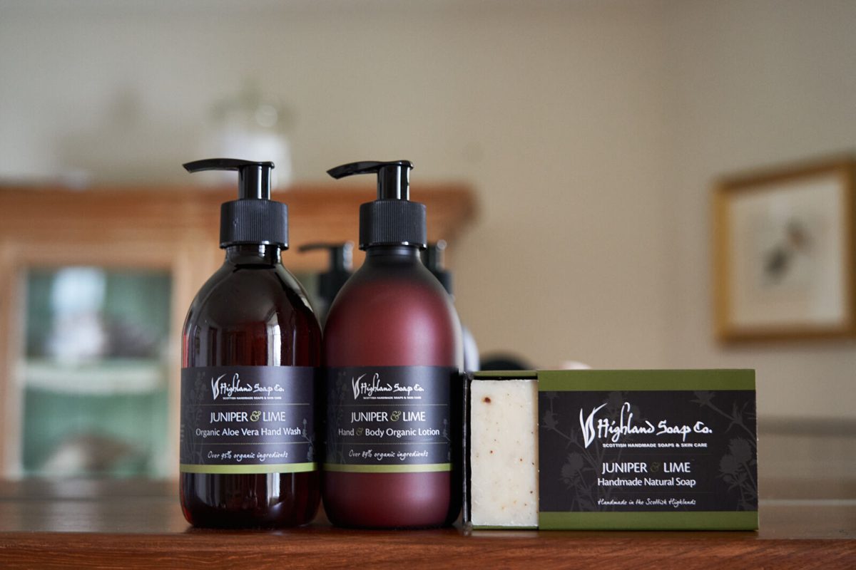 Juniper & Lime handzeep, lotion en zeep op een houten plank